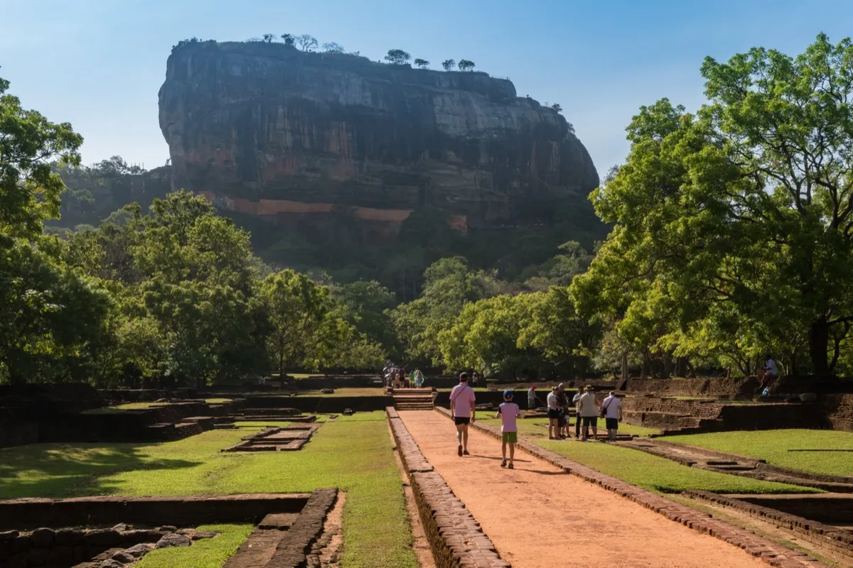 A path through the ancient water gardens at Sigiriya, with the great rock ahead