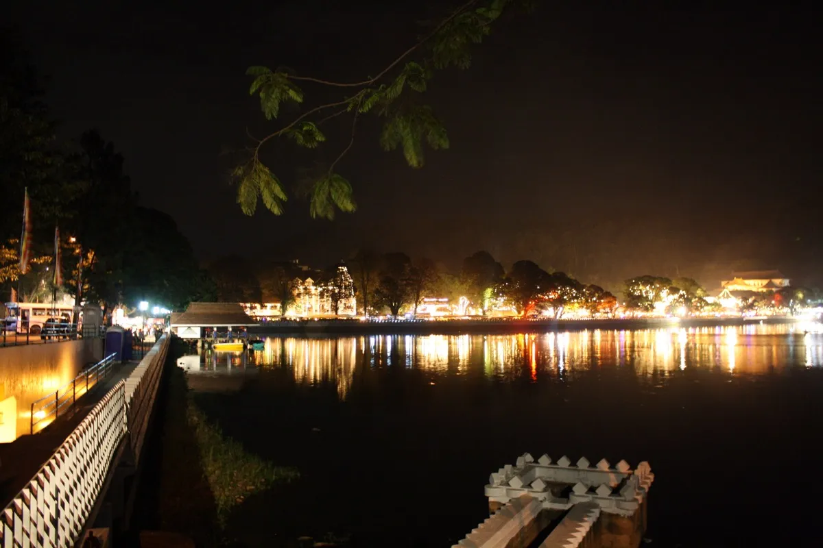 Kandy Lake at night with the lights of the Temple of the Tooth and the town reflected in the water