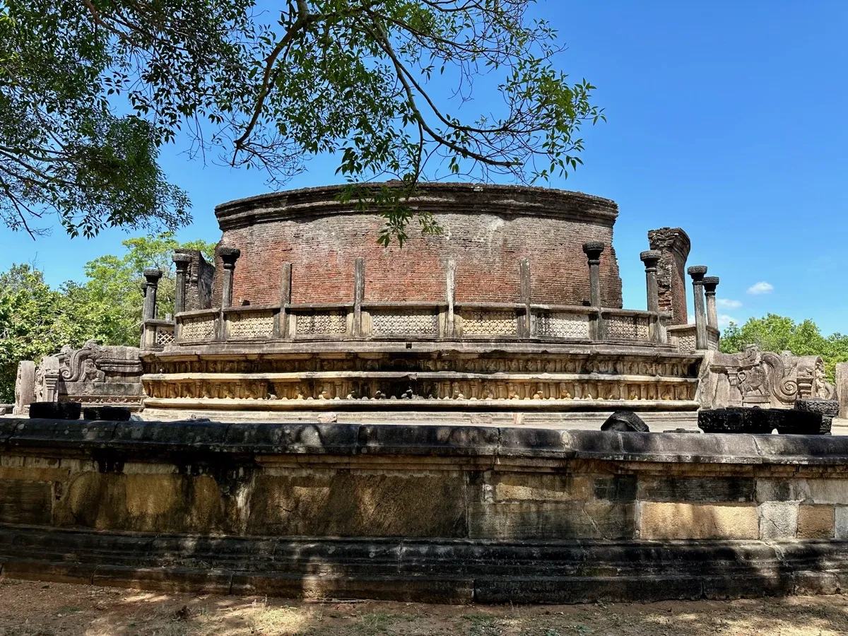 The circular brick and stone relic house, the Vatadage, in the Polonnaruwa Quadrangle under a blue sky