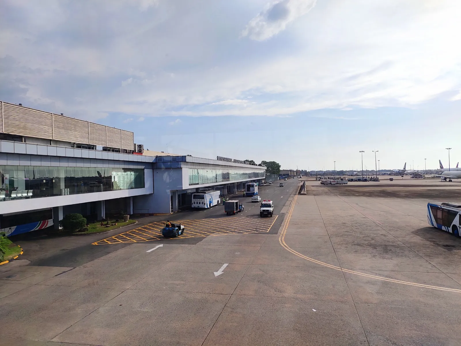 The terminal building of Bandaranaike International Airport near Colombo, seen from the apron side with buses parked